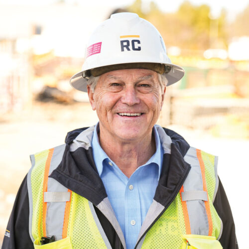 Older man in RC hard hat, blue shirt, safety vest.