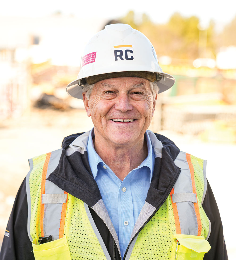 Older man in RC hard hat, blue shirt, safety vest.