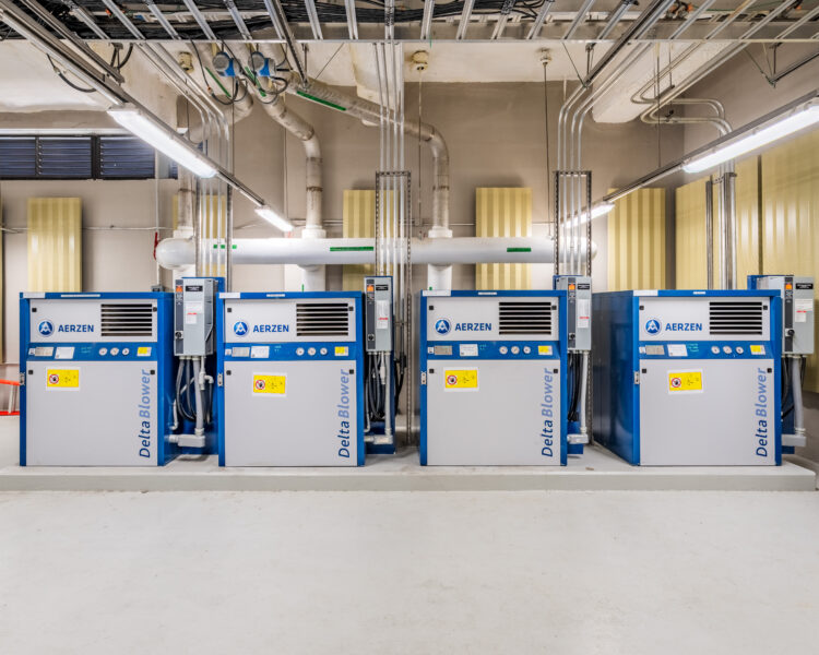 Four Delta Blower machines in a bright, tidy utility room.