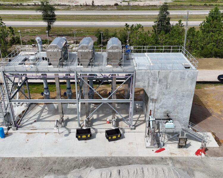 Aerial view of industrial facility with tanks and metal structures.