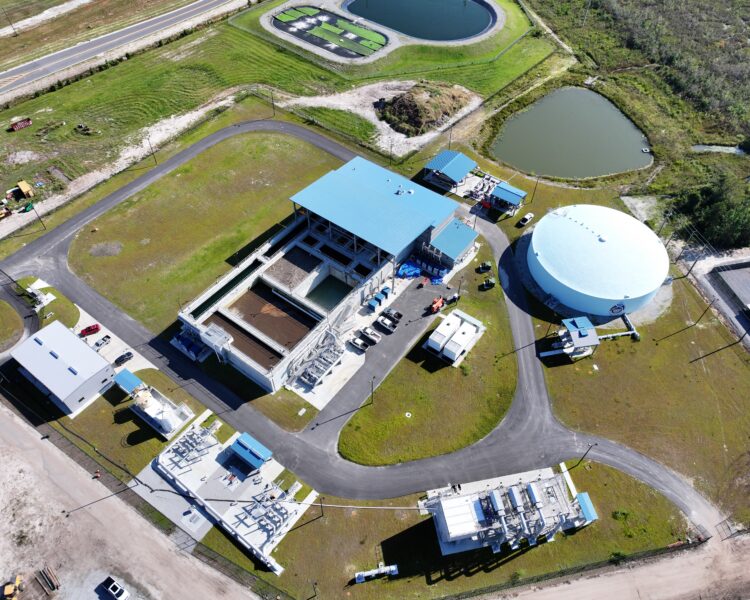 Aerial view of water treatment facility with tanks and ponds.