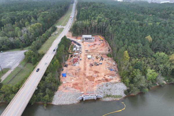 Obra junto al río y el bosque, cerca de una carretera muy transitada.