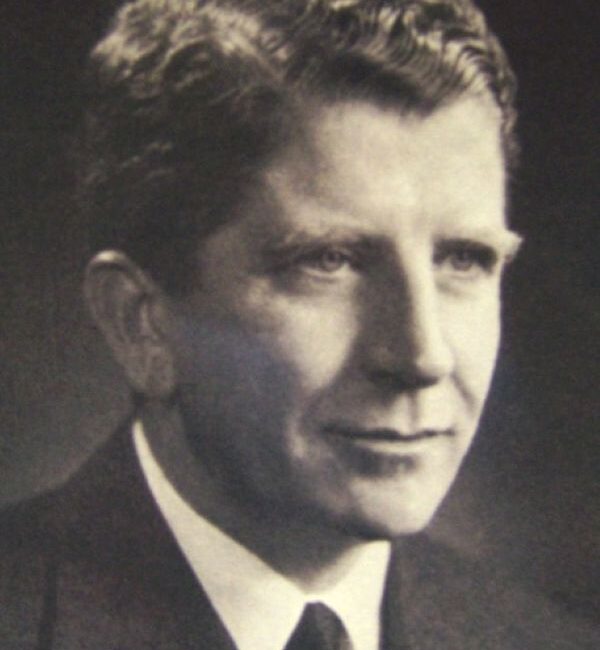 Black and white photo of a middle-aged man in a suit.